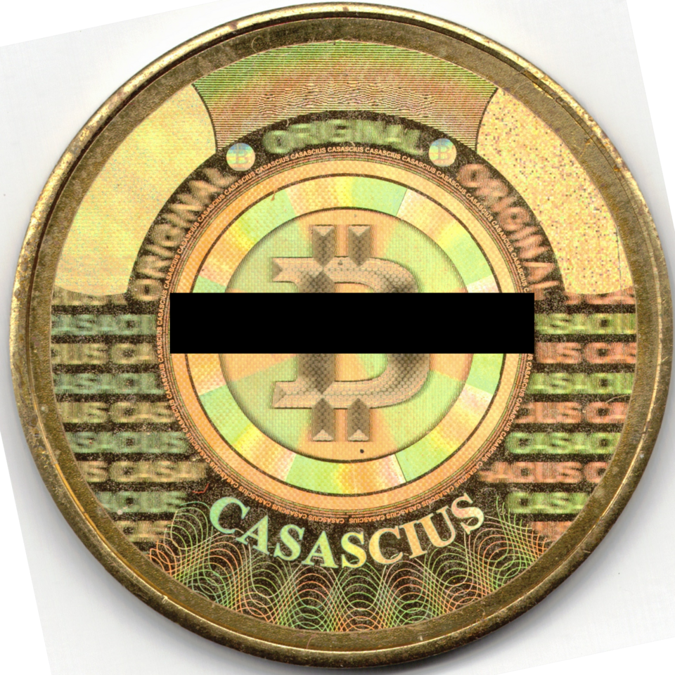 Casascius 2011 brass one bitcoin, hologram reverse; address obscured in source photograph