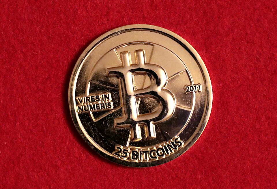 Casascius 25 Bitcoin coin dated 2011 on red fabric